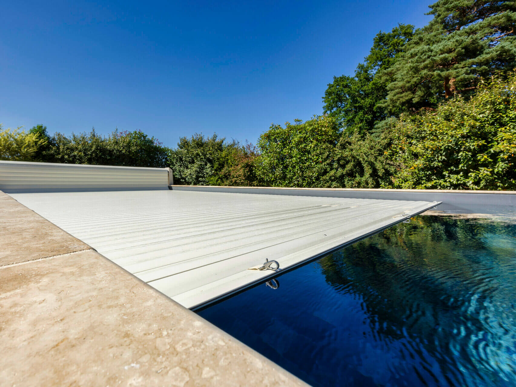Piscine avec protection et volet roulant.